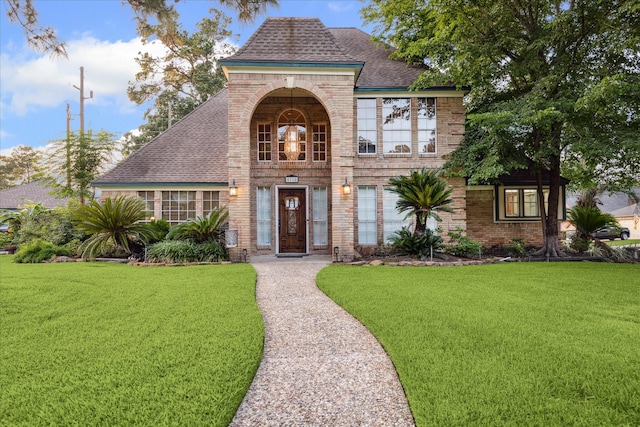 5718 Glenmere Ln, Spring, TX 77379 - view of front of property featuring brick siding, a front lawn, and a shingled roof