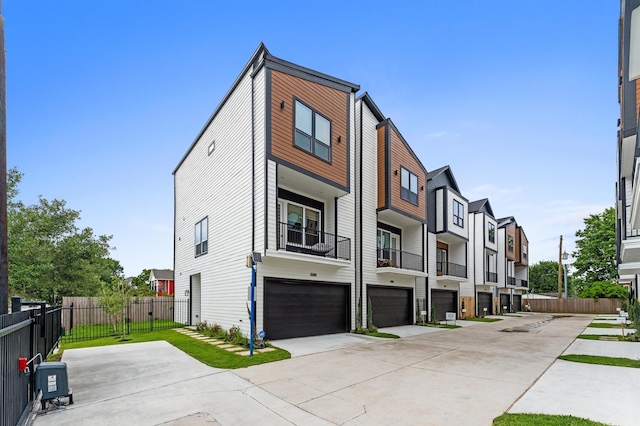 4013 Griggs Rd Unit H, Houston, TX 77021 - view of property featuring an attached garage, driveway, and a residential view