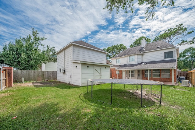 5722 Henniker Dr, Houston, TX 77041 - rear view of property with a trampoline, a chimney, central AC, brick siding, and an attached garage