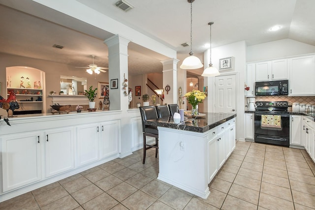 2 Camborn Pl, The Woodlands, TX 77384 - kitchen with black appliances, decorative columns, light tile patterned floors, ceiling fan, and a kitchen island