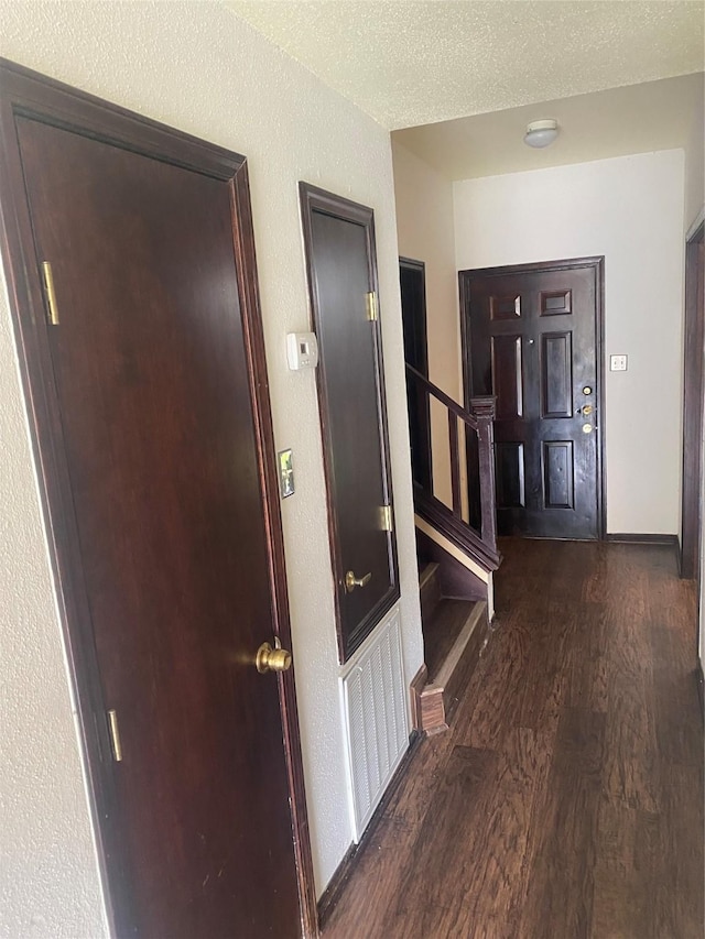 1201 Mcduffie St Unit 122, Houston, TX 77019 - corridor featuring dark wood-style floors, stairs, and a textured wall