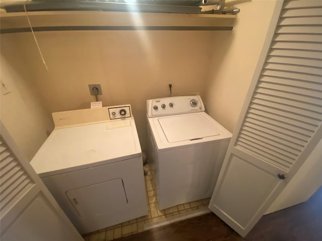 1201 Mcduffie St Unit 122, Houston, TX 77019 - laundry room with washer and dryer and dark wood-type flooring