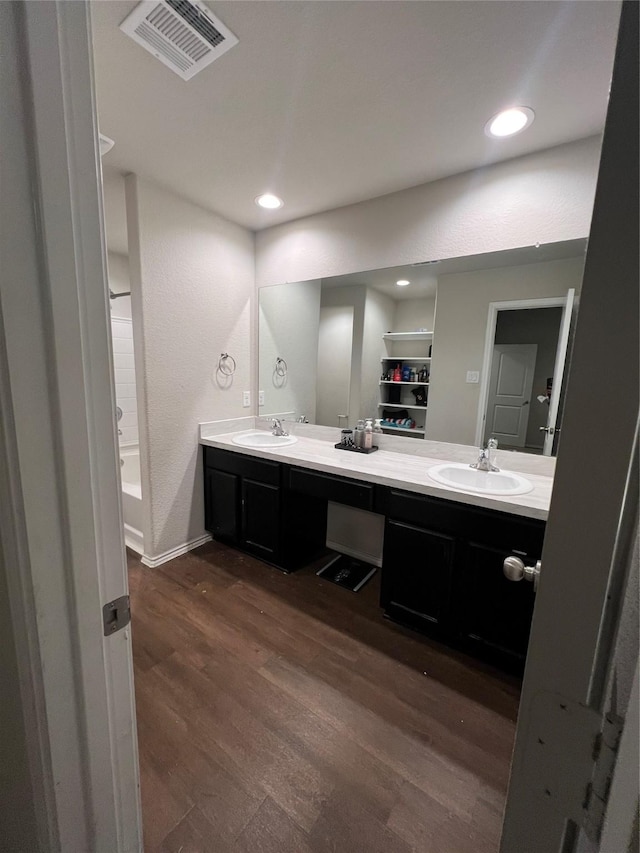 15466 Sicomoro Viejo St, Channelview, TX 77530 - bathroom with double vanity, wood finished floors, baseboards, recessed lighting, and a tub to relax in