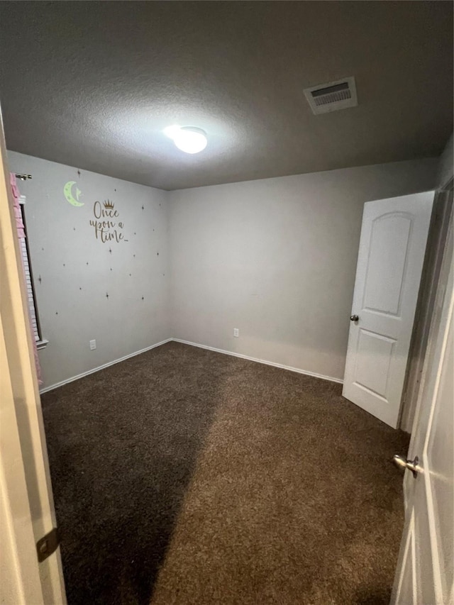 15466 Sicomoro Viejo St, Channelview, TX 77530 - unfurnished room with dark carpet, a textured ceiling, and baseboards