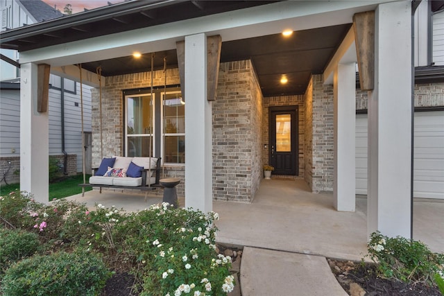127 Kingsley Grove St, Montgomery, TX 77316 - view of exterior entry featuring brick siding and covered porch