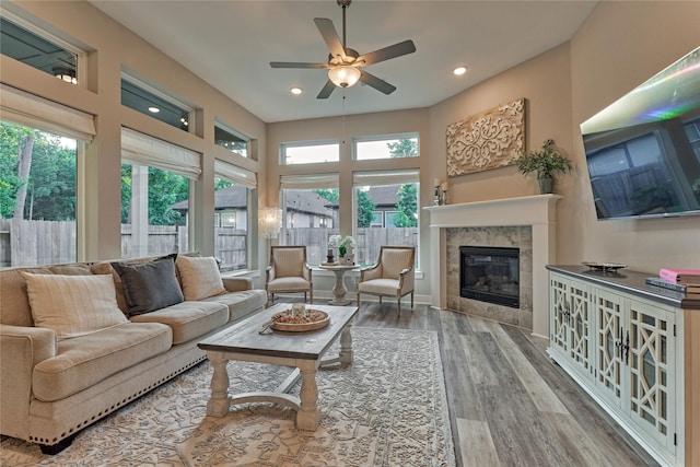 127 Kingsley Grove St, Montgomery, TX 77316 - living room featuring wood finished floors, a ceiling fan, healthy amount of natural light, a tiled fireplace, and recessed lighting