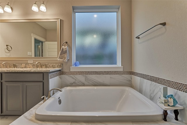 127 Kingsley Grove St, Montgomery, TX 77316 - full bathroom featuring vanity, a bath, and a textured wall