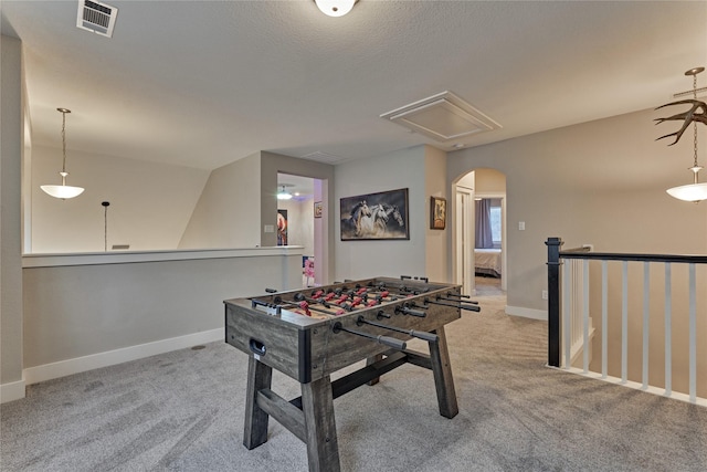 127 Kingsley Grove St, Montgomery, TX 77316 - recreation room with arched walkways, carpet flooring, attic access, and baseboards