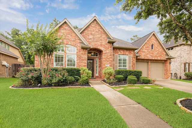 28314 Shining Creek Ln, Spring, TX 77386 - traditional-style house featuring brick siding, a garage, driveway, and roof with shingles
