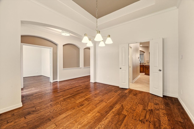 28314 Shining Creek Ln, Spring, TX 77386 - spare room featuring a chandelier, wood finished floors, baseboards, a high ceiling, and ornamental molding