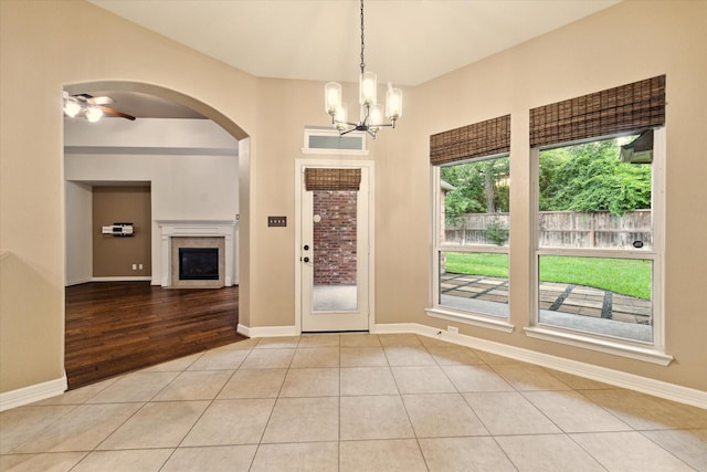 28314 Shining Creek Ln, Spring, TX 77386 - entryway featuring a chandelier, a fireplace, arched walkways, baseboards, and ceiling fan