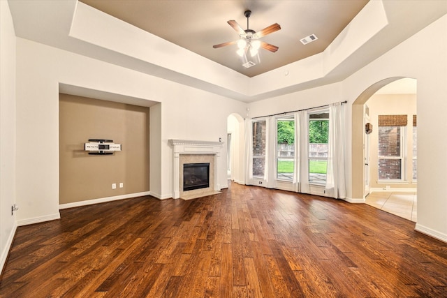 28314 Shining Creek Ln, Spring, TX 77386 - unfurnished living room featuring a premium fireplace, wood finished floors, ceiling fan, a tray ceiling, and baseboards