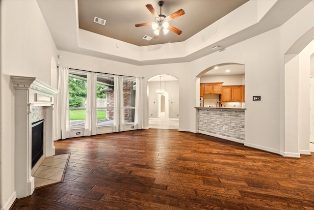 28314 Shining Creek Ln, Spring, TX 77386 - unfurnished living room with a tray ceiling, dark wood-style floors, a ceiling fan, and baseboards