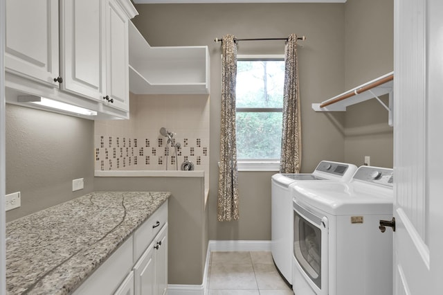 11415 W Kristina Cir, Montgomery, TX 77316 - laundry room featuring independent washer and dryer, cabinet space, and light tile patterned flooring
