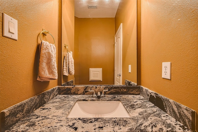 7207 Alder Springs Ct, Katy, TX 77494 - bathroom with a textured wall and vanity
