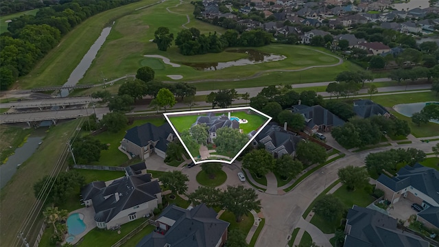 7207 Alder Springs Ct, Katy, TX 77494 - aerial overview of property's location with a large body of water, nearby suburban area, property boundaries highlighted, and a golf course
