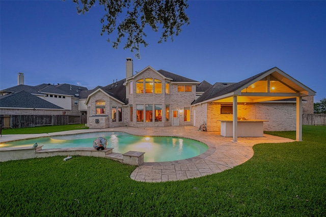 7207 Alder Springs Ct, Katy, TX 77494 - rear view of house with a patio area, a chimney, and brick siding