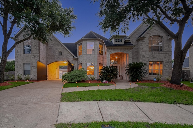 7207 Alder Springs Ct, Katy, TX 77494 - french provincial home featuring a front yard, stone siding, and driveway