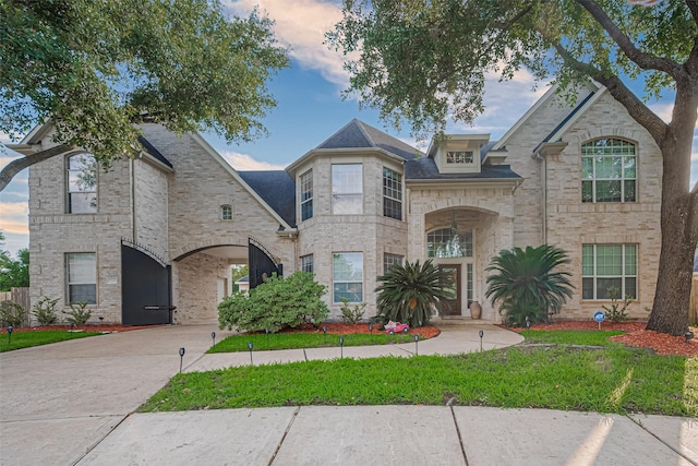 7207 Alder Springs Ct, Katy, TX 77494 - french country style house featuring a yard, driveway, and brick siding