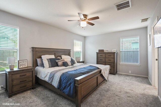 647 Cypresswood Trce, Spring, TX 77373 - bedroom featuring multiple windows, carpet, baseboards, and a ceiling fan