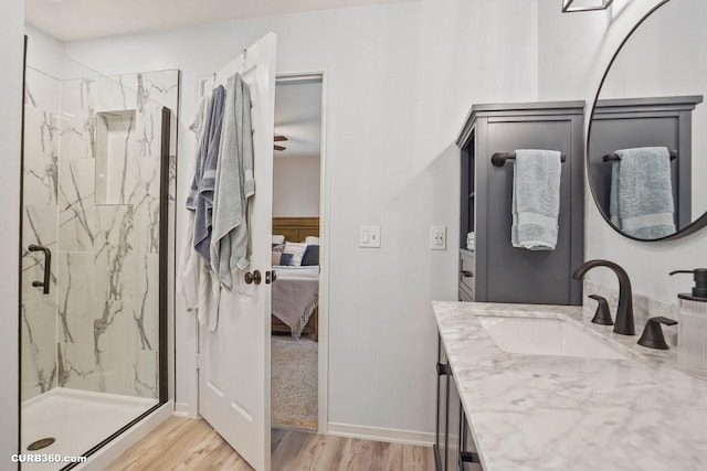 647 Cypresswood Trce, Spring, TX 77373 - ensuite bathroom featuring a marble finish shower, wood finished floors, and vanity