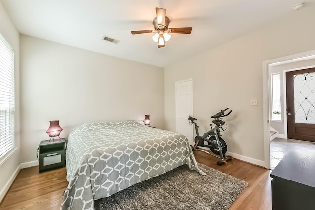 1513 Nagle St, Houston, TX 77003 - bedroom featuring multiple windows, light wood-type flooring, and a ceiling fan