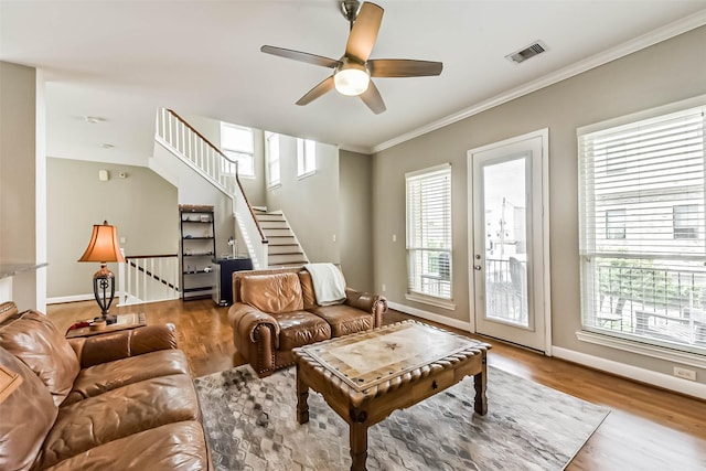 1513 Nagle St, Houston, TX 77003 - living room featuring plenty of natural light, ceiling fan, wood finished floors, ornamental molding, and stairs