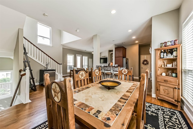 1513 Nagle St, Houston, TX 77003 - dining space with wood finished floors, stairway, and recessed lighting