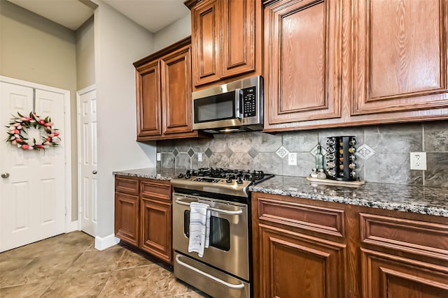 1513 Nagle St, Houston, TX 77003 - kitchen with appliances with stainless steel finishes, decorative backsplash, dark stone counters, and brown cabinets