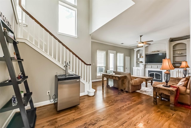 1513 Nagle St, Houston, TX 77003 - living area with a fireplace, stairway, wood finished floors, ornamental molding, and ceiling fan