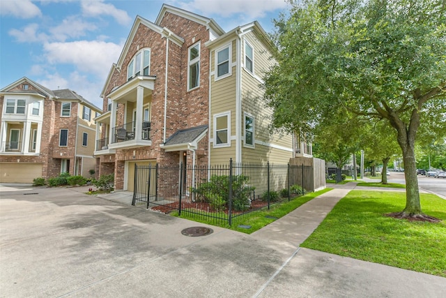 1513 Nagle St, Houston, TX 77003 - townhome / multi-family property with brick siding, a garage, driveway, and a residential view