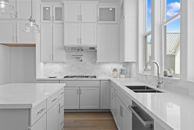 8711 Park Kolbe Ln, Houston, TX 77080 - kitchen with a sink, stainless steel dishwasher, decorative backsplash, and white cabinets