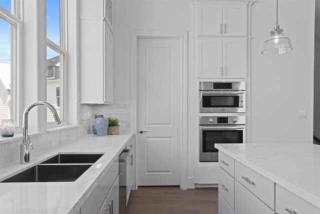 8711 Park Kolbe Ln, Houston, TX 77080 - kitchen with a sink, white cabinetry, light stone counters, and appliances with stainless steel finishes