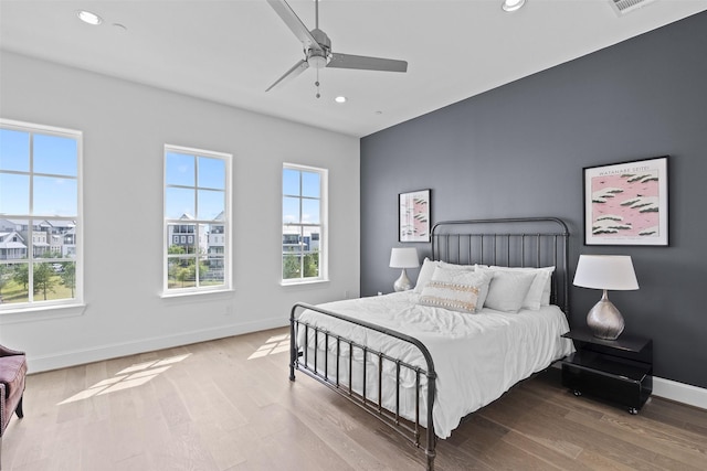 8711 Park Kolbe Ln, Houston, TX 77080 - bedroom featuring multiple windows, baseboards, recessed lighting, wood finished floors, and ceiling fan