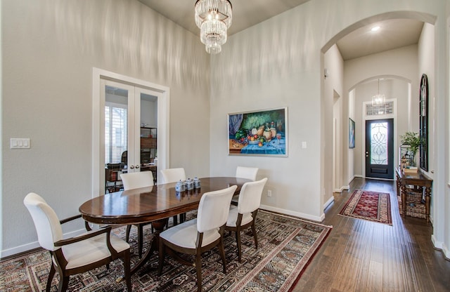 7118 Pondhawk Dr, Katy, TX 77493 - dining room with arched walkways, baseboards, dark wood finished floors, plenty of natural light, and a high ceiling