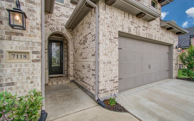 7118 Pondhawk Dr, Katy, TX 77493 - doorway to property featuring brick siding, driveway, and a garage