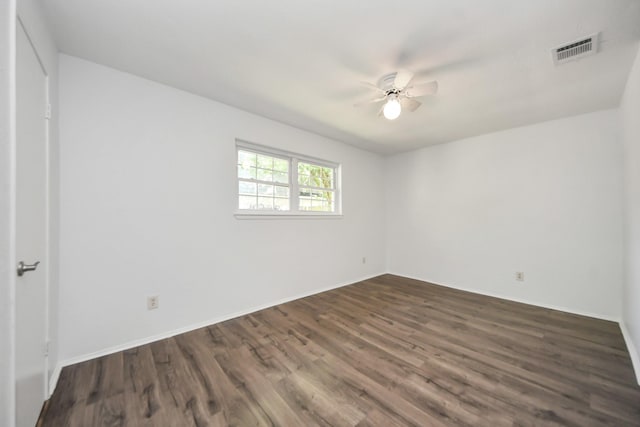 1409 N Park Ridge Dr, Deer Park, TX 77536 - unfurnished bedroom with dark wood-type flooring, baseboards, and a ceiling fan