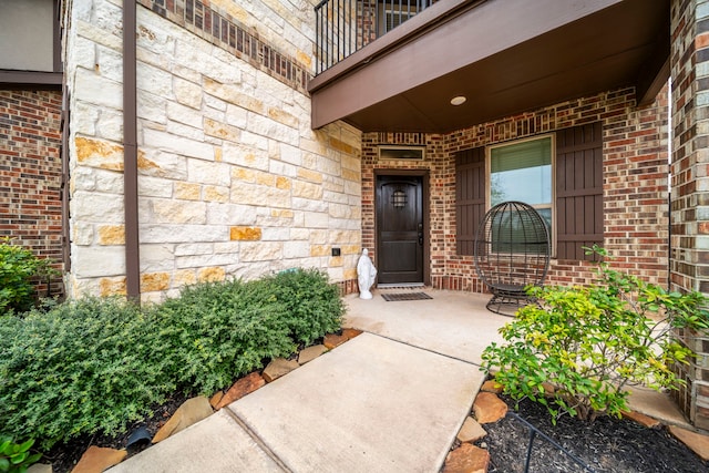 1111 White Winter Ct, Richmond, TX 77406 - property entrance with brick siding, stone siding, a balcony, and covered porch