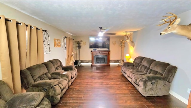 18042 Noble Forest Dr, Humble, TX 77346 - living area featuring a fireplace, dark wood-style floors, and baseboards