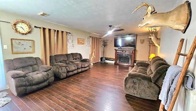 18042 Noble Forest Dr, Humble, TX 77346 - living room featuring a fireplace and dark wood-style floors