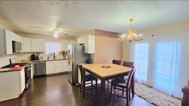 18042 Noble Forest Dr, Humble, TX 77346 - dining room with a chandelier, dark wood-type flooring, and a ceiling fan