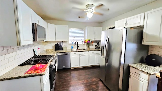 18042 Noble Forest Dr, Humble, TX 77346 - kitchen featuring appliances with stainless steel finishes, a sink, tasteful backsplash, dark wood-style floors, and ceiling fan