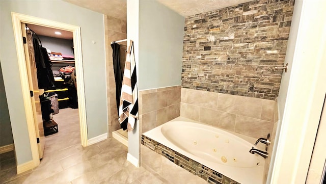 18042 Noble Forest Dr, Humble, TX 77346 - bathroom featuring a shower stall, a jetted tub, a spacious closet, baseboards, and tile patterned floors
