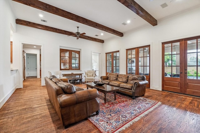 5418 Braeburn Dr, Bellaire, TX 77401 - living room with french doors, a ceiling fan, wood finished floors, beam ceiling, and healthy amount of natural light