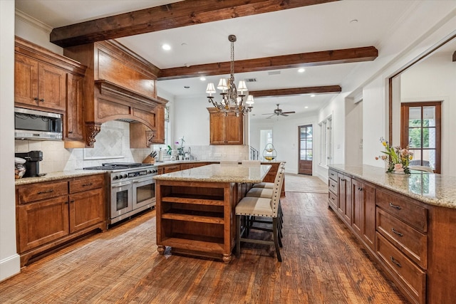 5418 Braeburn Dr, Bellaire, TX 77401 - kitchen featuring appliances with stainless steel finishes, beam ceiling, backsplash, dark wood-style floors, and a kitchen island