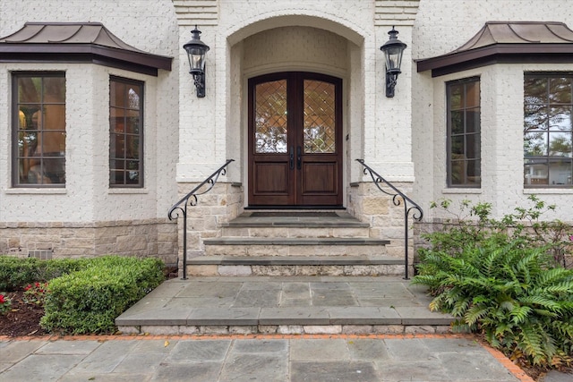 5418 Braeburn Dr, Bellaire, TX 77401 - doorway to property with a standing seam roof and stone siding
