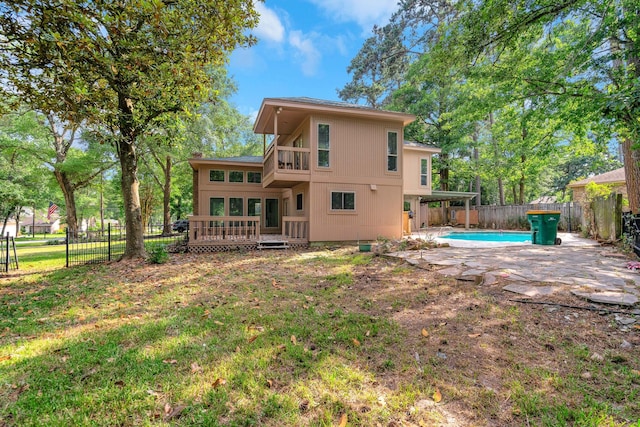 35 Greentree Ln, Conroe, TX 77304 - rear view of property featuring a patio area, a balcony, and a deck