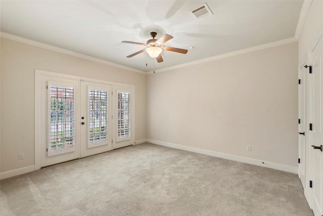 2403 Commonwealth St, Houston, TX 77006 - spare room featuring ceiling fan, light carpet, baseboards, crown molding, and french doors