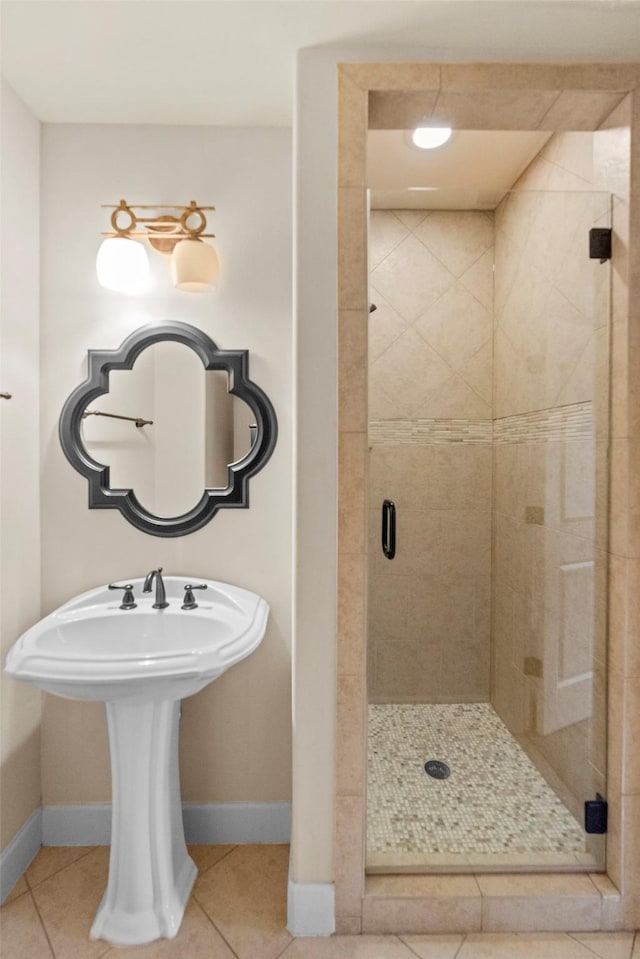 2403 Commonwealth St, Houston, TX 77006 - bathroom with baseboards, a shower stall, and tile patterned flooring