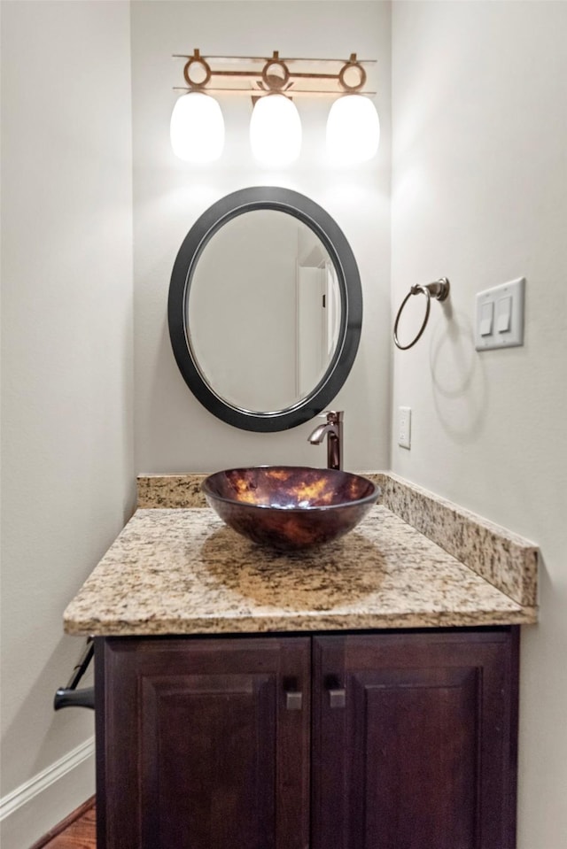 2403 Commonwealth St, Houston, TX 77006 - bathroom with vanity, wood finished floors, and baseboards